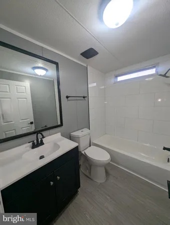 a bathroom with a double vanity sink toilet a mirror and shower