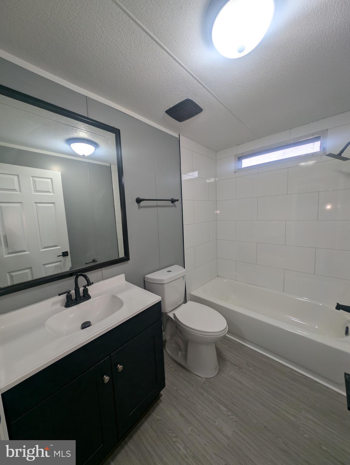 1926 Fletcher Road Aberdeen, MD 21001 - Photo 9 of 15 a bathroom with a double vanity sink toilet a mirror and shower