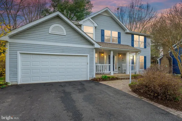a front view of house with garage and green space