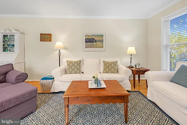a living room with furniture and a lamp