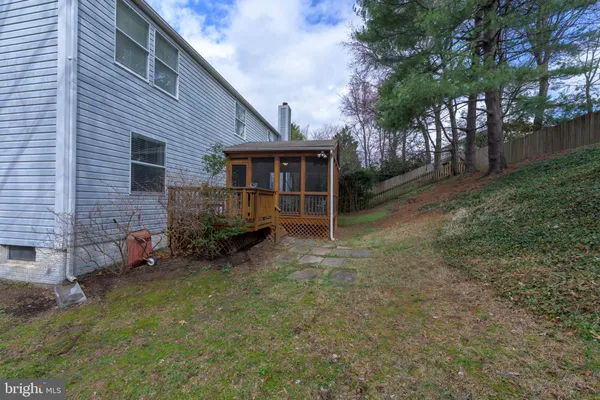 a view of a house with a yard and a fire pit