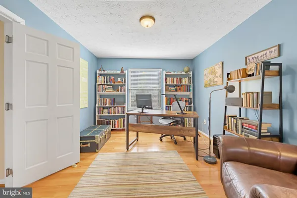 a living room with furniture and a book shelf