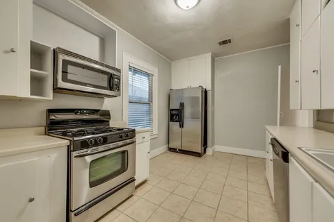 a kitchen with a stove and a refrigerator