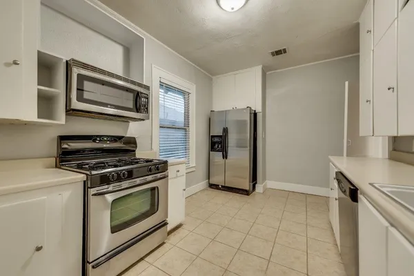 a kitchen with a stove and a refrigerator
