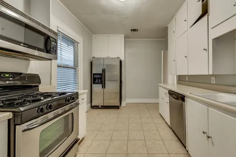 a kitchen with stainless steel appliances granite countertop a stove and a refrigerator