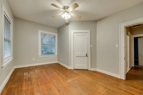 wooden floor in an empty room with a window