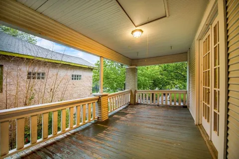 a view of a balcony with wooden floor