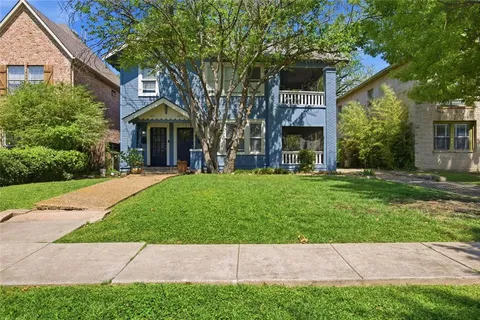 a view of house with yard and front view of a house