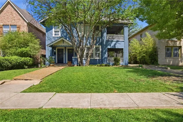 a view of house with yard and front view of a house