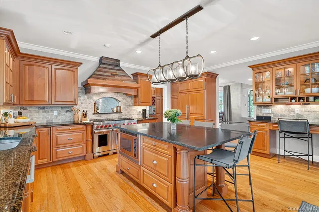 a living room with fireplace furniture and a large window