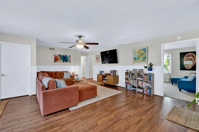 a living room with furniture window and wooden floor