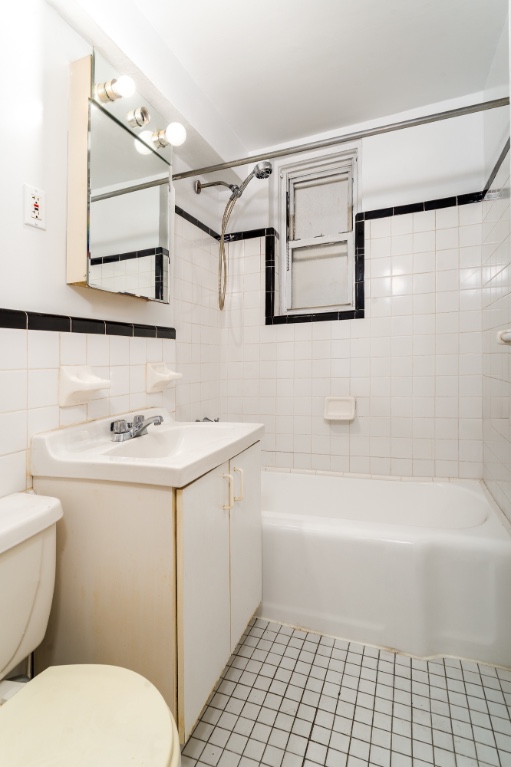5610 Netherland Avenue, Unit 1G Bronx, NY 10471 - Photo 12 of 17 a bathroom with a sink a toilet and shower