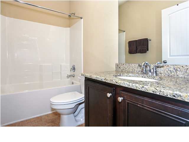 14 Riverbirch Loop Santa Rosa Beach, FL 32459 - Photo 13 of 20 a bathroom with a granite countertop sink toilet a large mirror a bathtub and shower