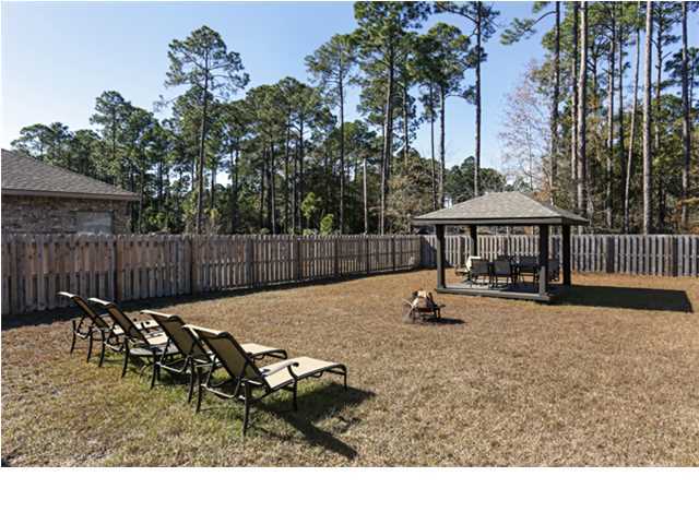 14 Riverbirch Loop Santa Rosa Beach, FL 32459 - Photo 16 of 20 a backyard of a house with table and chairs