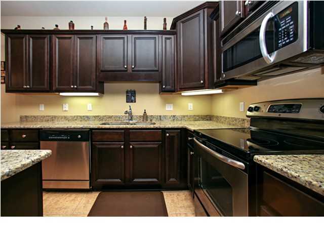 14 Riverbirch Loop Santa Rosa Beach, FL 32459 - Photo 5 of 20 a kitchen with granite countertop a stove a sink and cabinets