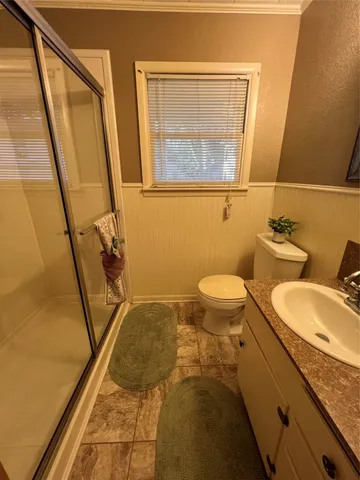 a bathroom with a granite countertop sink toilet and a mirror