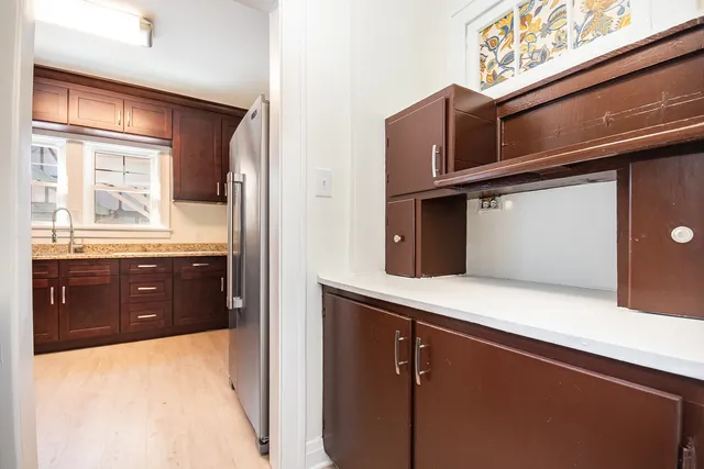 a kitchen with stainless steel appliances granite countertop a refrigerator and a sink