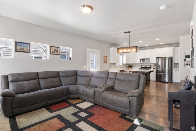 5155 East Rio Grande Way Eagle Mountain, UT 84005 - Photo 5 of 40 Living area with dark wood-type flooring and recessed lighting