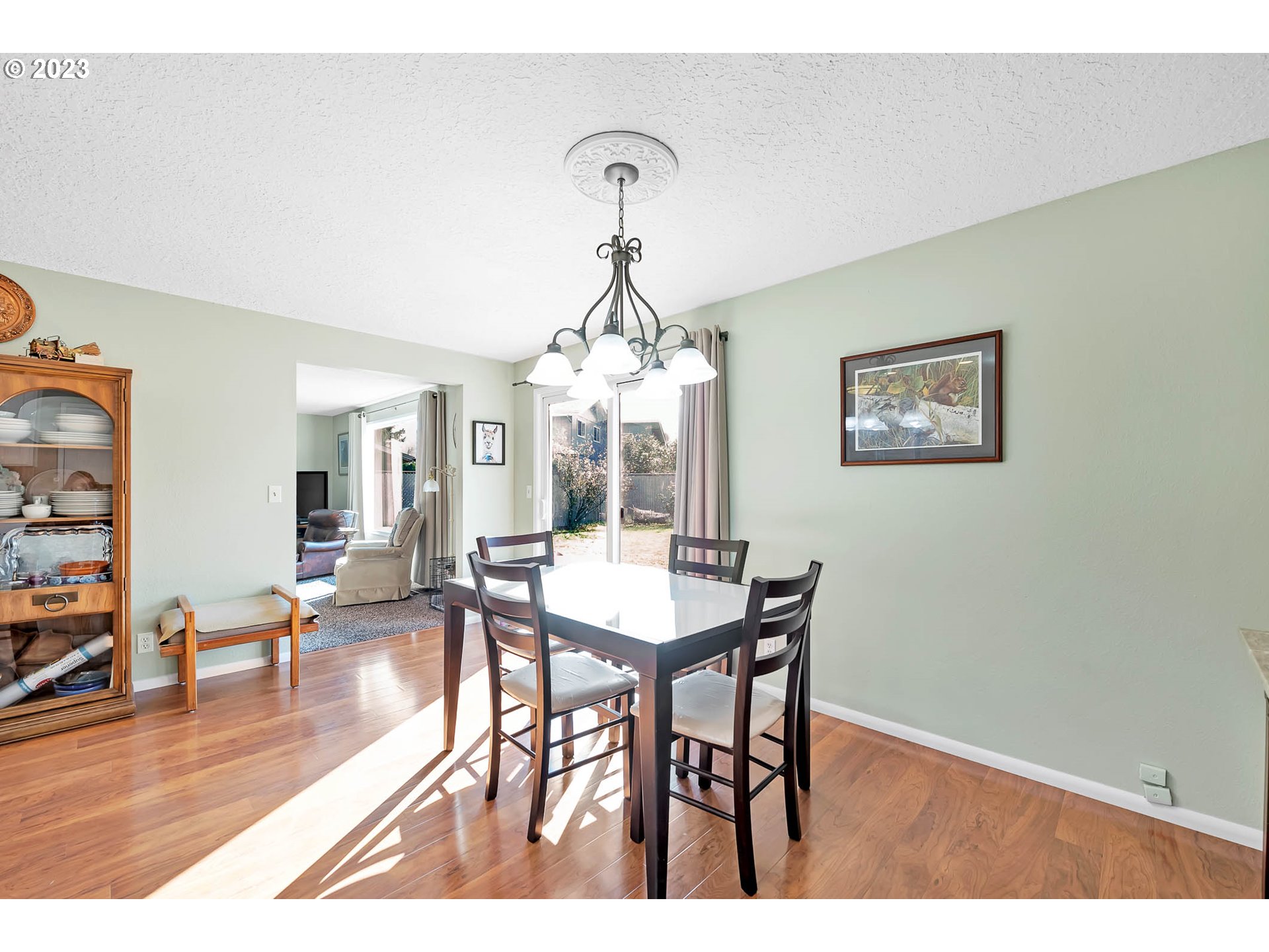 576 67th Street Springfield, OR 97478 - Photo 9 of 32 a view of a dining room with furniture wooden floor and a chandelier