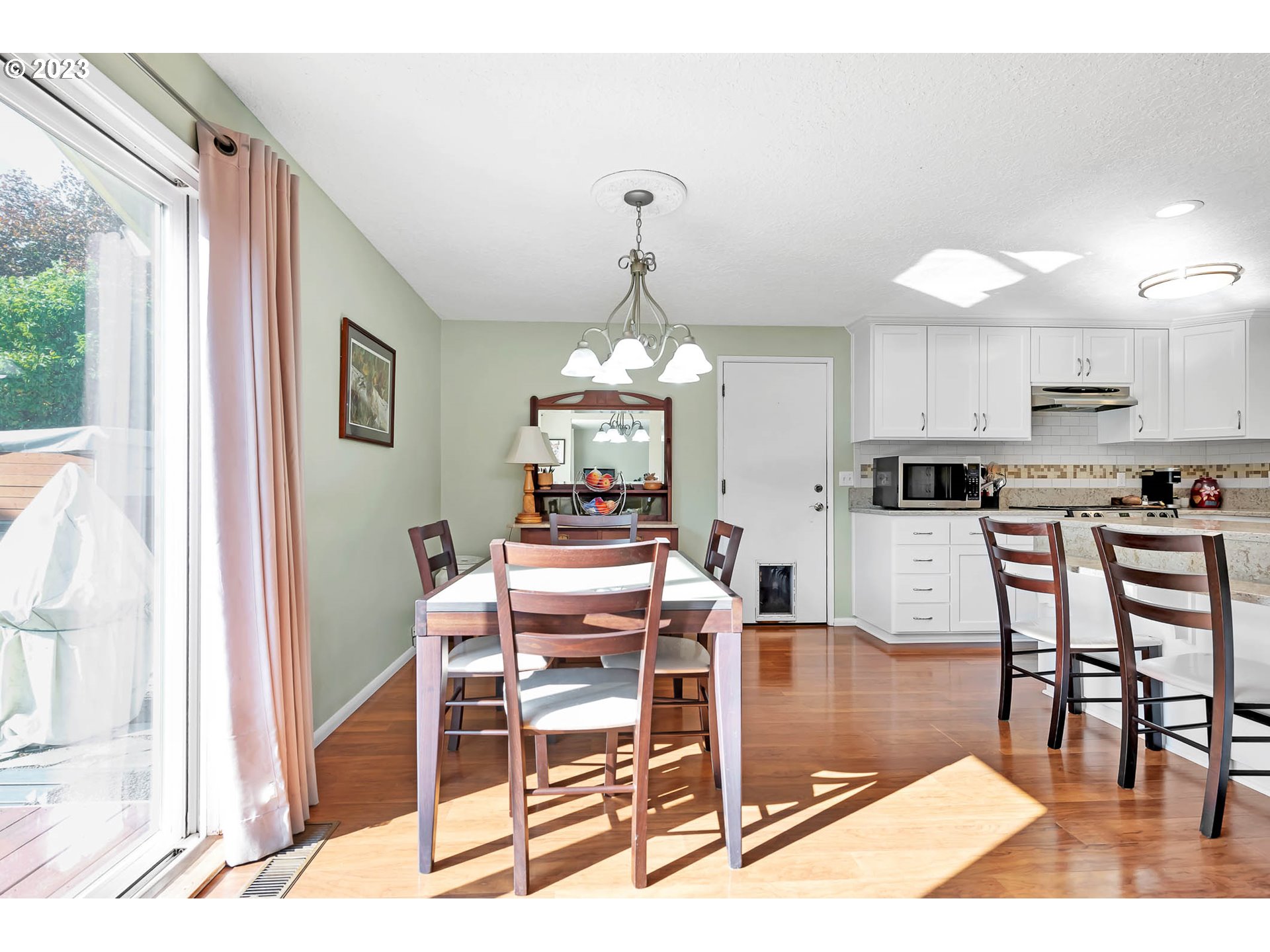576 67th Street Springfield, OR 97478 - Photo 10 of 32 a dining room with wooden floor and a chandelier