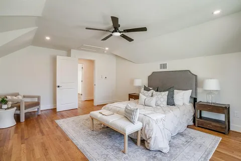 a bedroom with furniture and a wooden floor