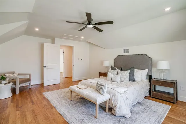 a bedroom with furniture and a wooden floor