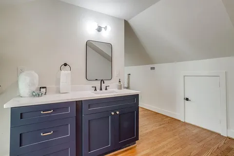a bathroom with a double vanity sink and a mirror