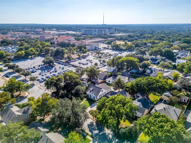 an aerial view of multiple house with a yard