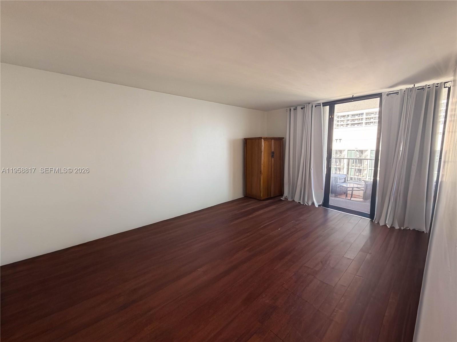 555 Northeast 15th Street, Unit PHF Miami, FL 33132 - Photo 11 of 17 an empty room with wooden floor and windows