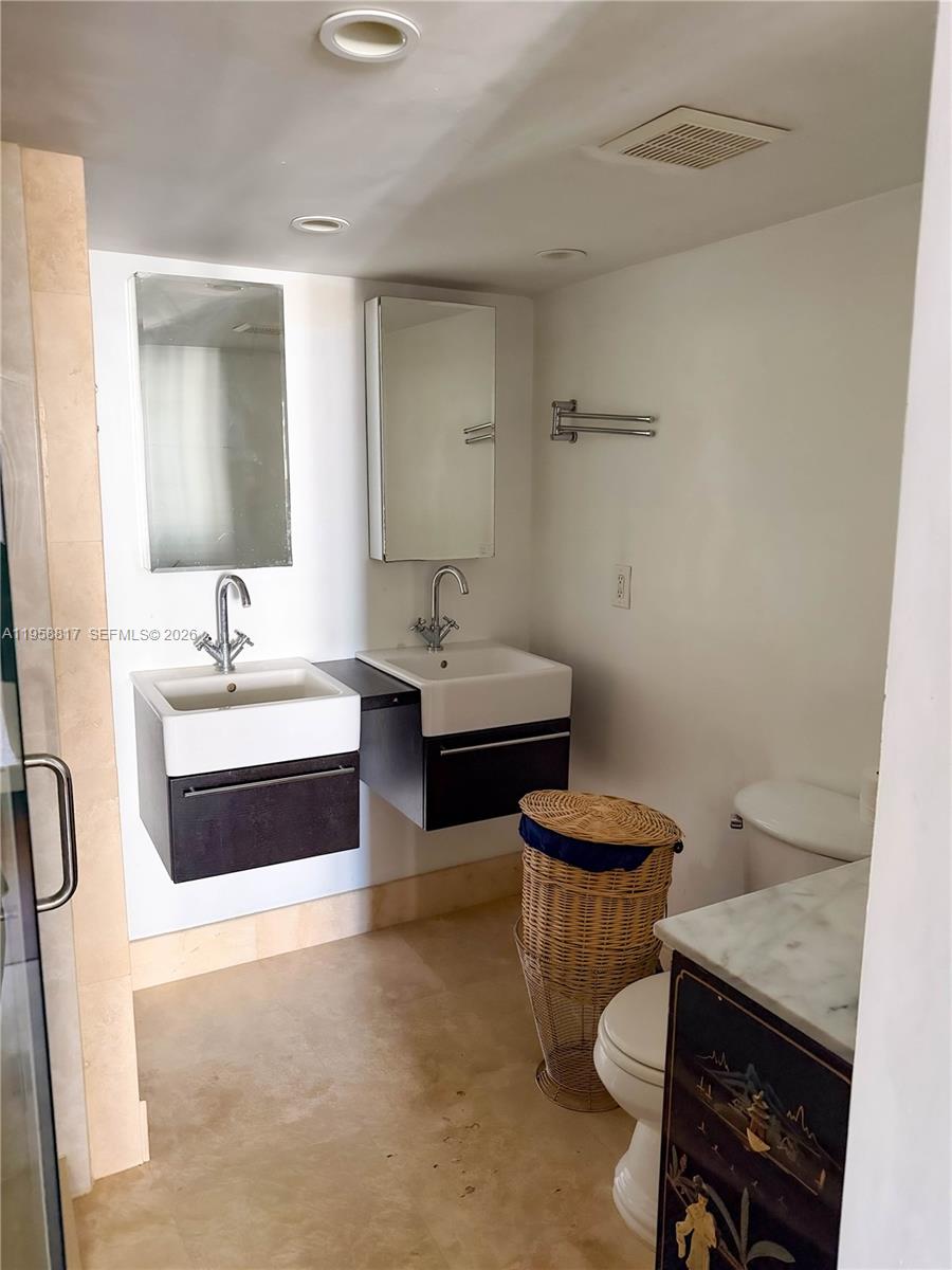 555 Northeast 15th Street, Unit PHF Miami, FL 33132 - Photo 13 of 17 a bathroom with a double vanity sink a toilet and a mirror