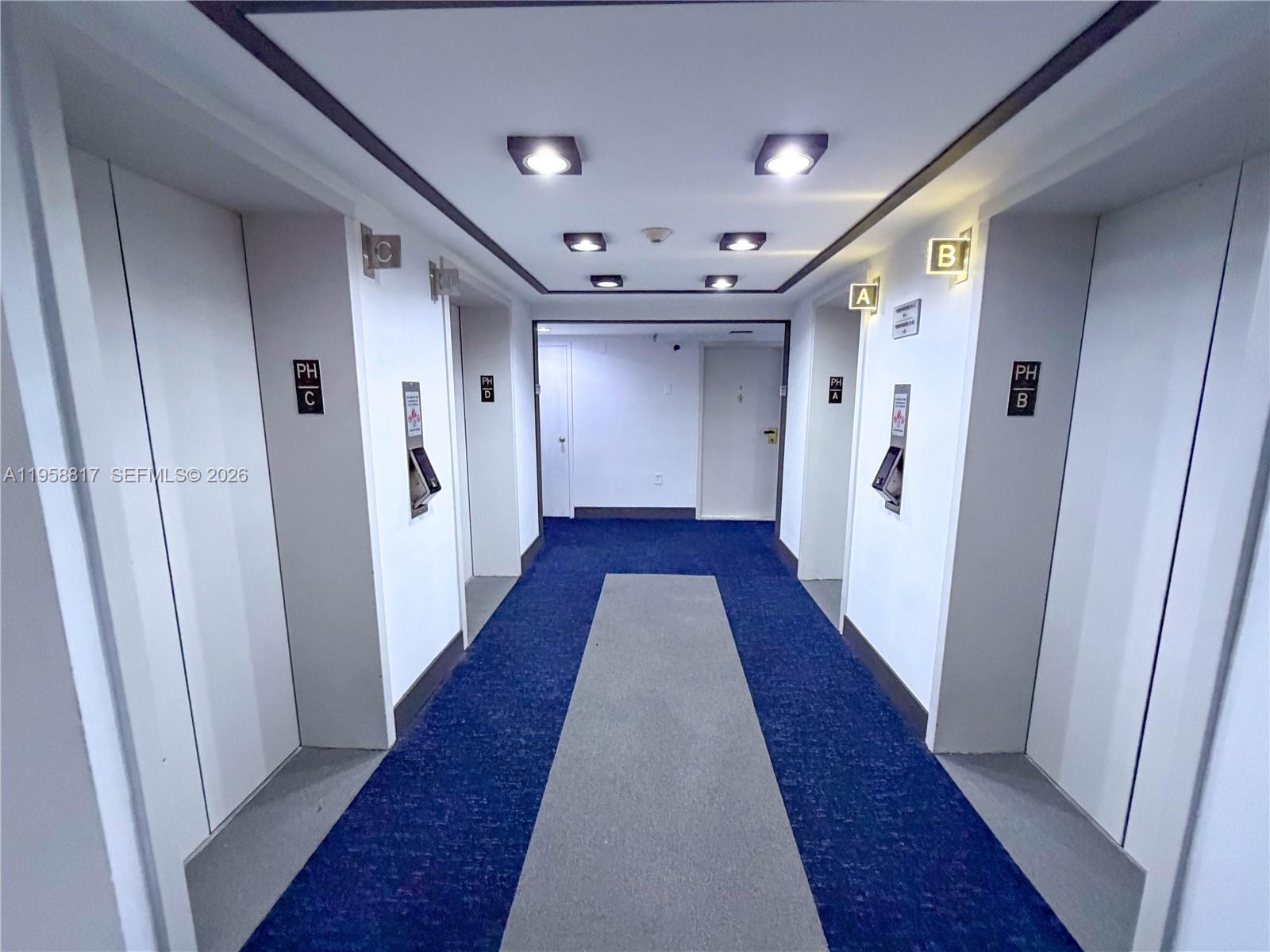 555 Northeast 15th Street, Unit PHF Miami, FL 33132 - Photo 16 of 17 a view of a hallway with wooden floor and staircase