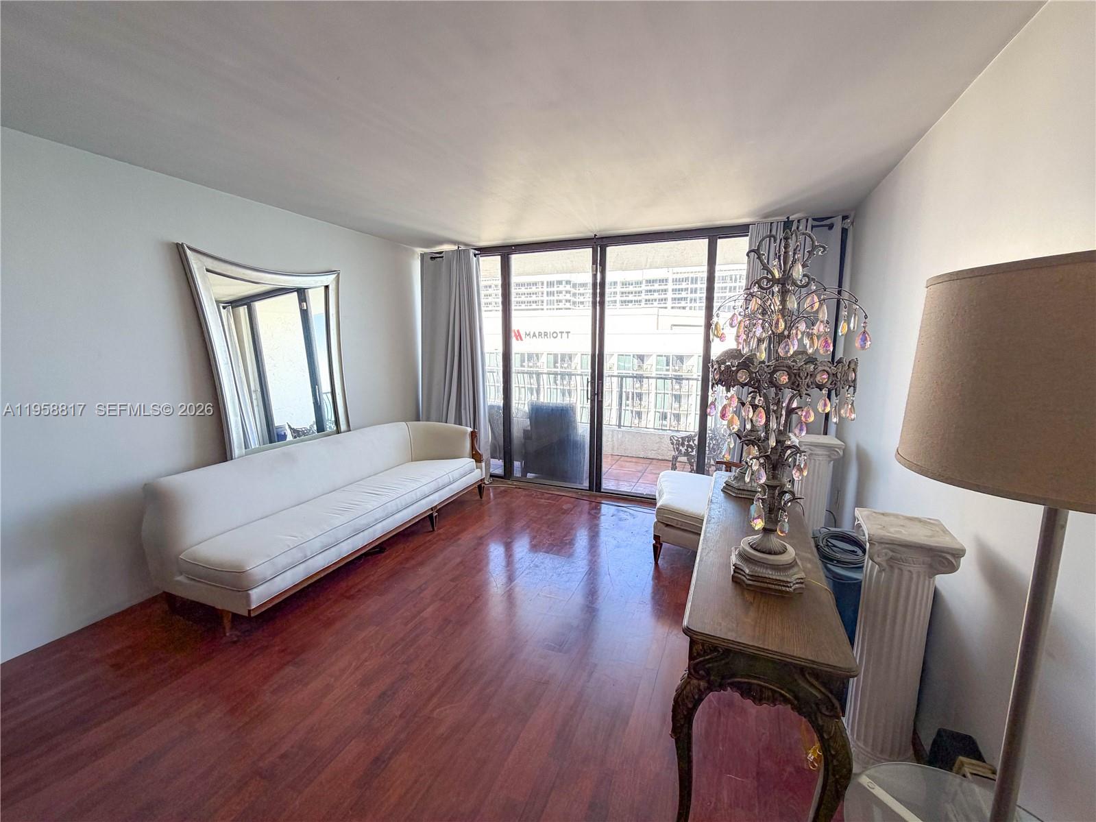 555 Northeast 15th Street, Unit PHF Miami, FL 33132 - Photo 4 of 17 a living room with furniture and a window