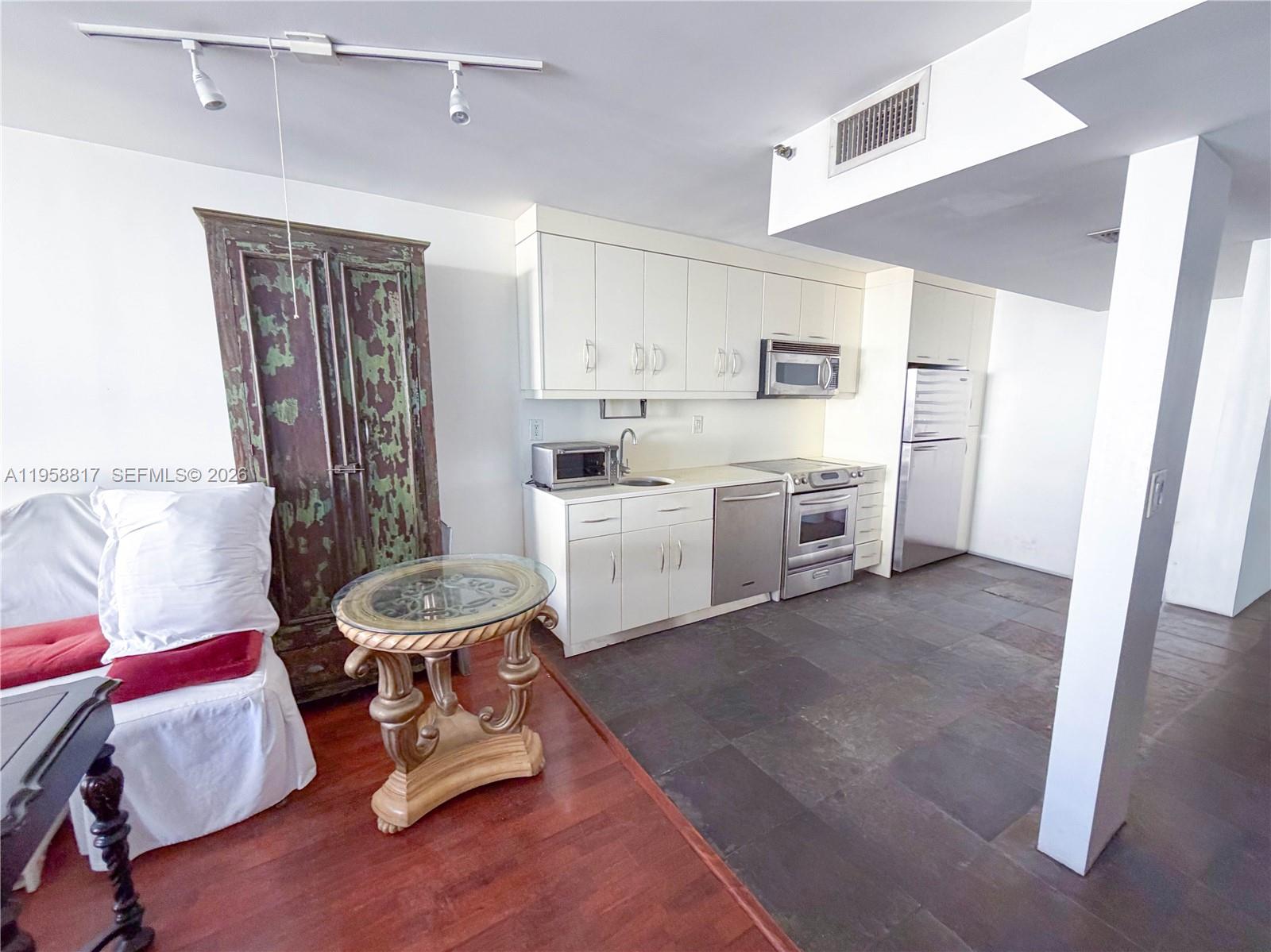 555 Northeast 15th Street, Unit PHF Miami, FL 33132 - Photo 6 of 17 a living room with furniture and a wooden floor