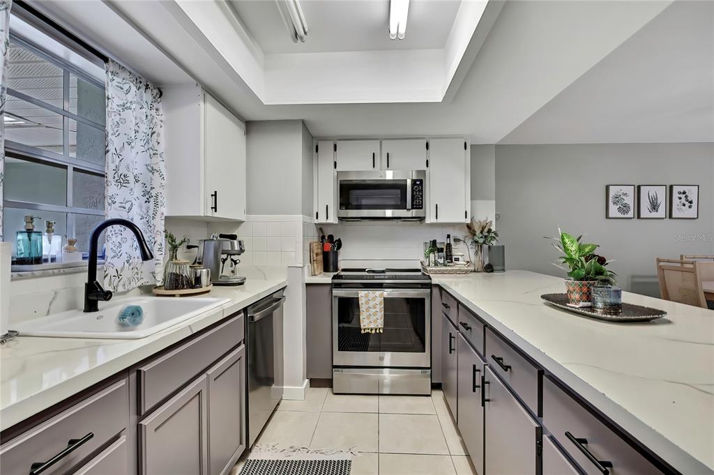 368 Portland Avenue Spring Hill, FL 34606 - Photo 20 of 38 a kitchen with kitchen island granite countertop a sink stainless steel appliances and cabinets