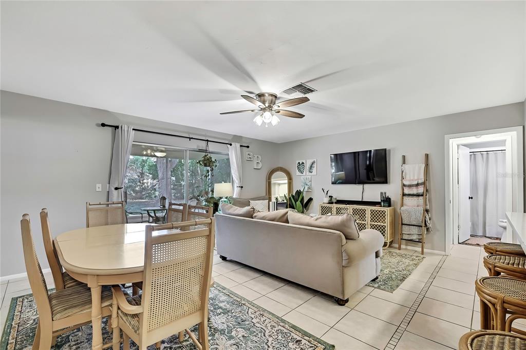 368 Portland Avenue Spring Hill, FL 34606 - Photo 21 of 38 a living room with furniture a flat screen tv and a large window