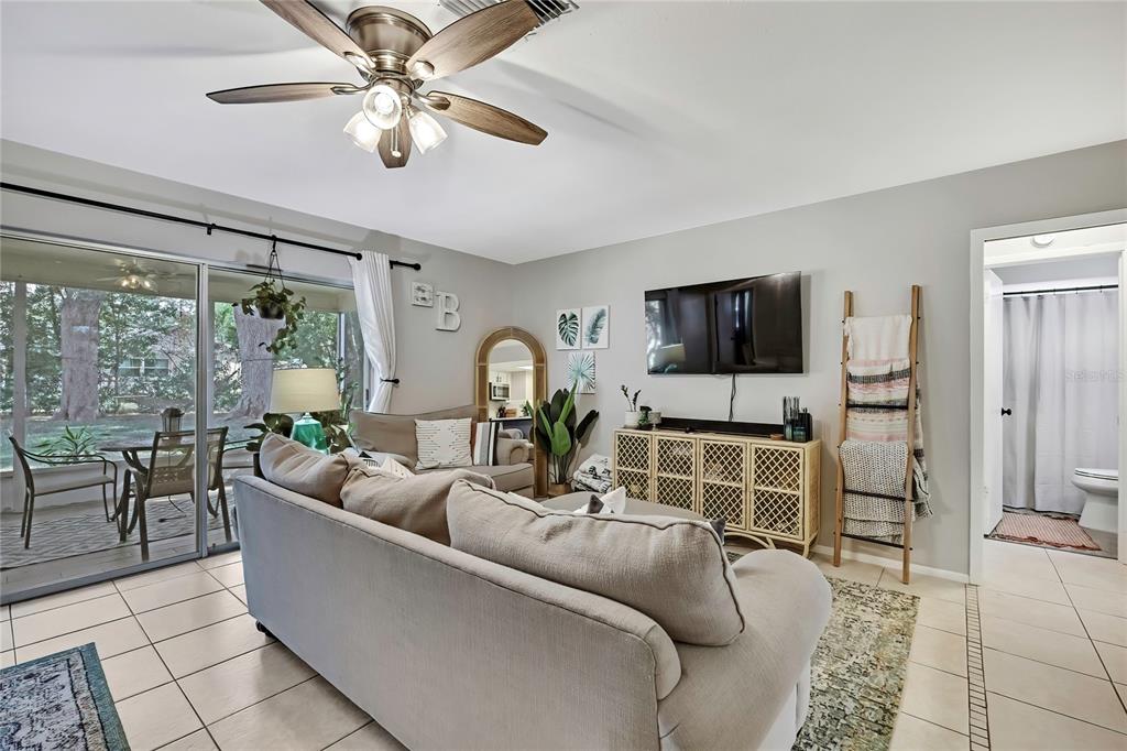 368 Portland Avenue Spring Hill, FL 34606 - Photo 24 of 38 a living room with furniture a flat screen tv and a large window