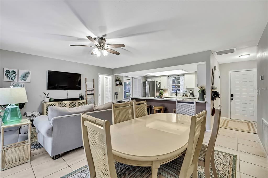 368 Portland Avenue Spring Hill, FL 34606 - Photo 25 of 38 a living room with furniture a flat screen tv and kitchen view
