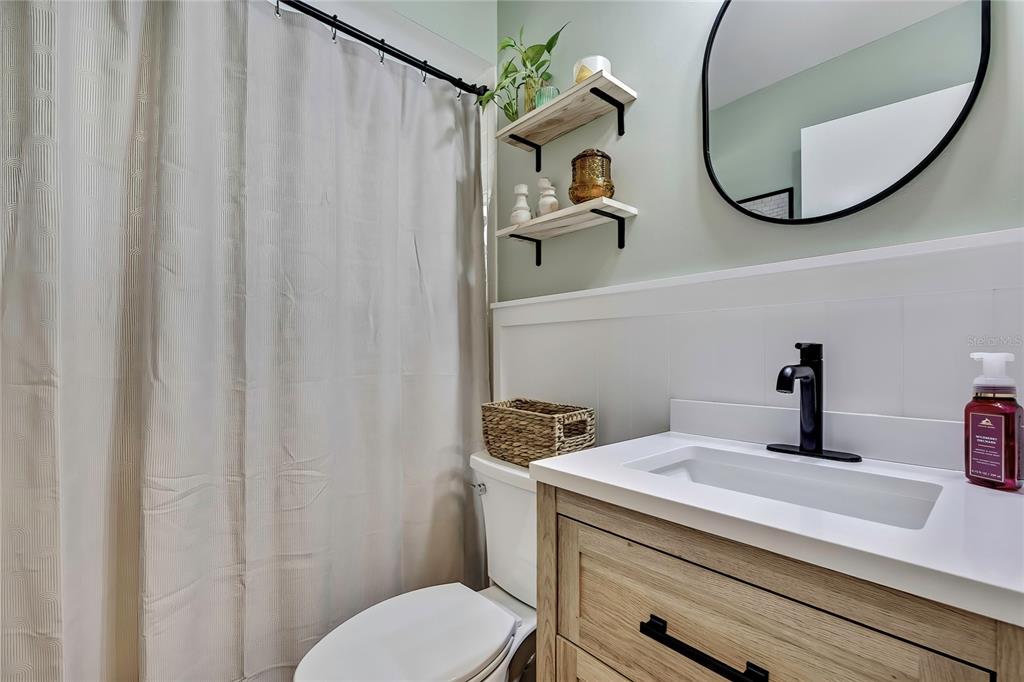 368 Portland Avenue Spring Hill, FL 34606 - Photo 29 of 38 a bathroom with a sink and mirror with toilet