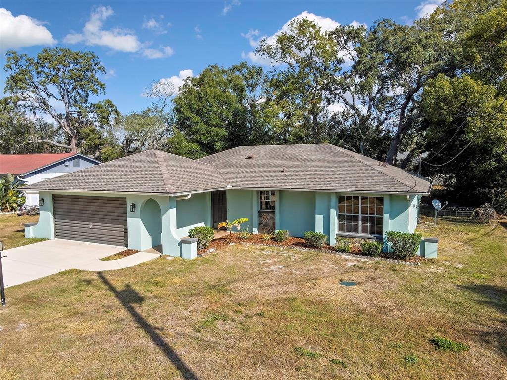 368 Portland Avenue Spring Hill, FL 34606 - Photo 5 of 38 a front view of a house with a yard