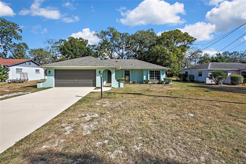 368 Portland Avenue Spring Hill, FL 34606 - Photo 7 of 38 a front view of a house with garden
