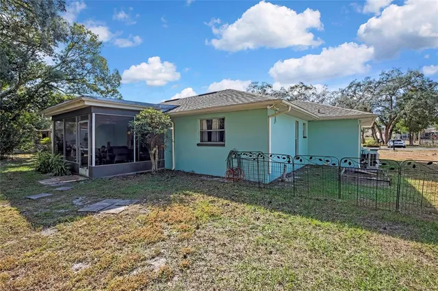 a backyard of a house with table and chairs
