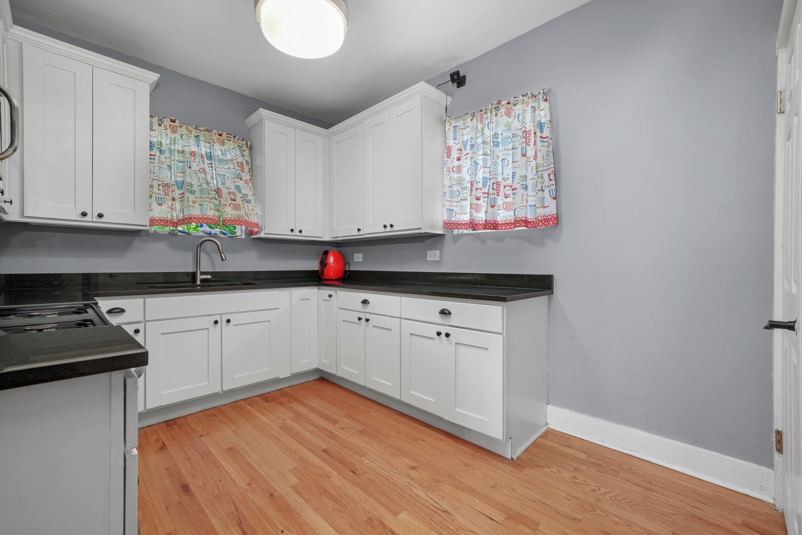 5648 Hawthorne Avenue Berkeley, IL 60163 - Photo 11 of 25 a kitchen with granite countertop white cabinets white appliances and a sink