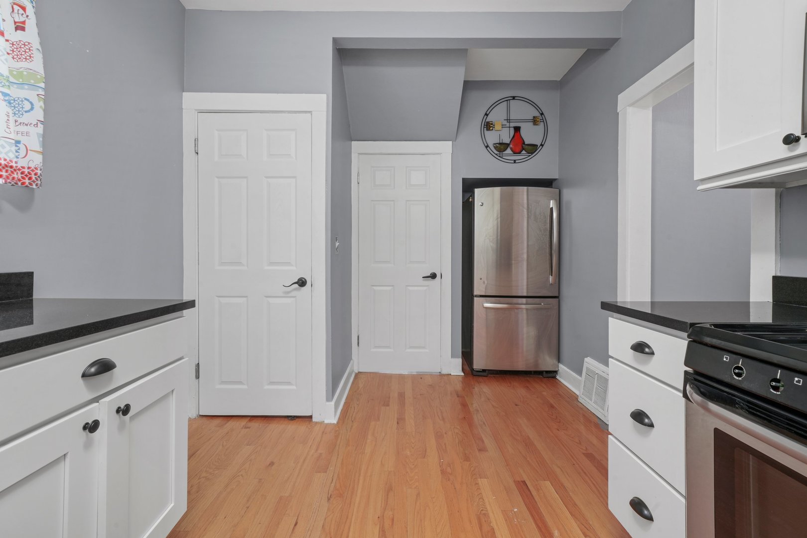 5648 Hawthorne Avenue Berkeley, IL 60163 - Photo 13 of 25 a kitchen with stainless steel appliances a refrigerator stove and wooden floor