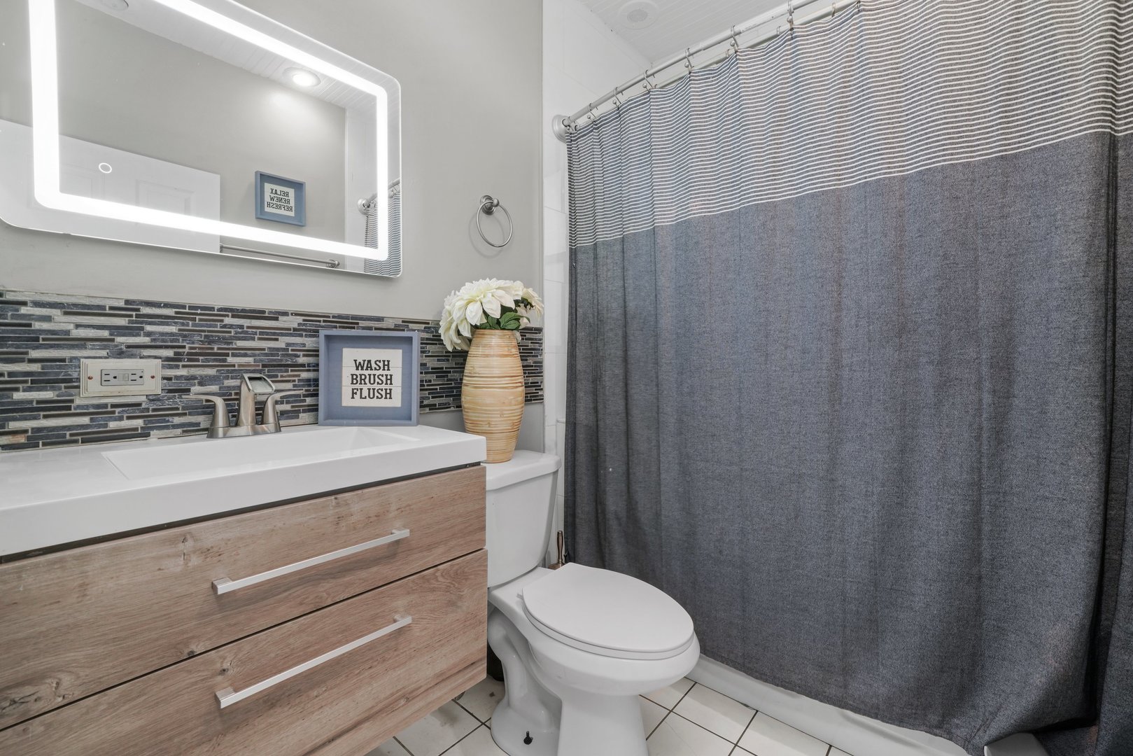 5648 Hawthorne Avenue Berkeley, IL 60163 - Photo 15 of 25 a bathroom with a granite countertop toilet sink and mirror