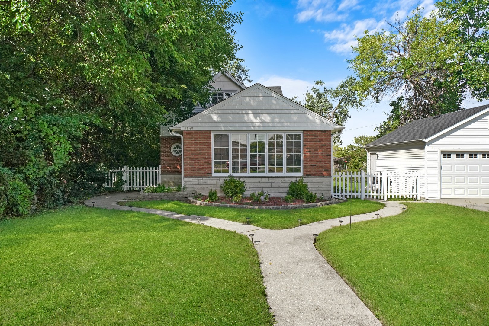 5648 Hawthorne Avenue Berkeley, IL 60163 - Photo 2 of 25 a front view of a house with a yard and porch