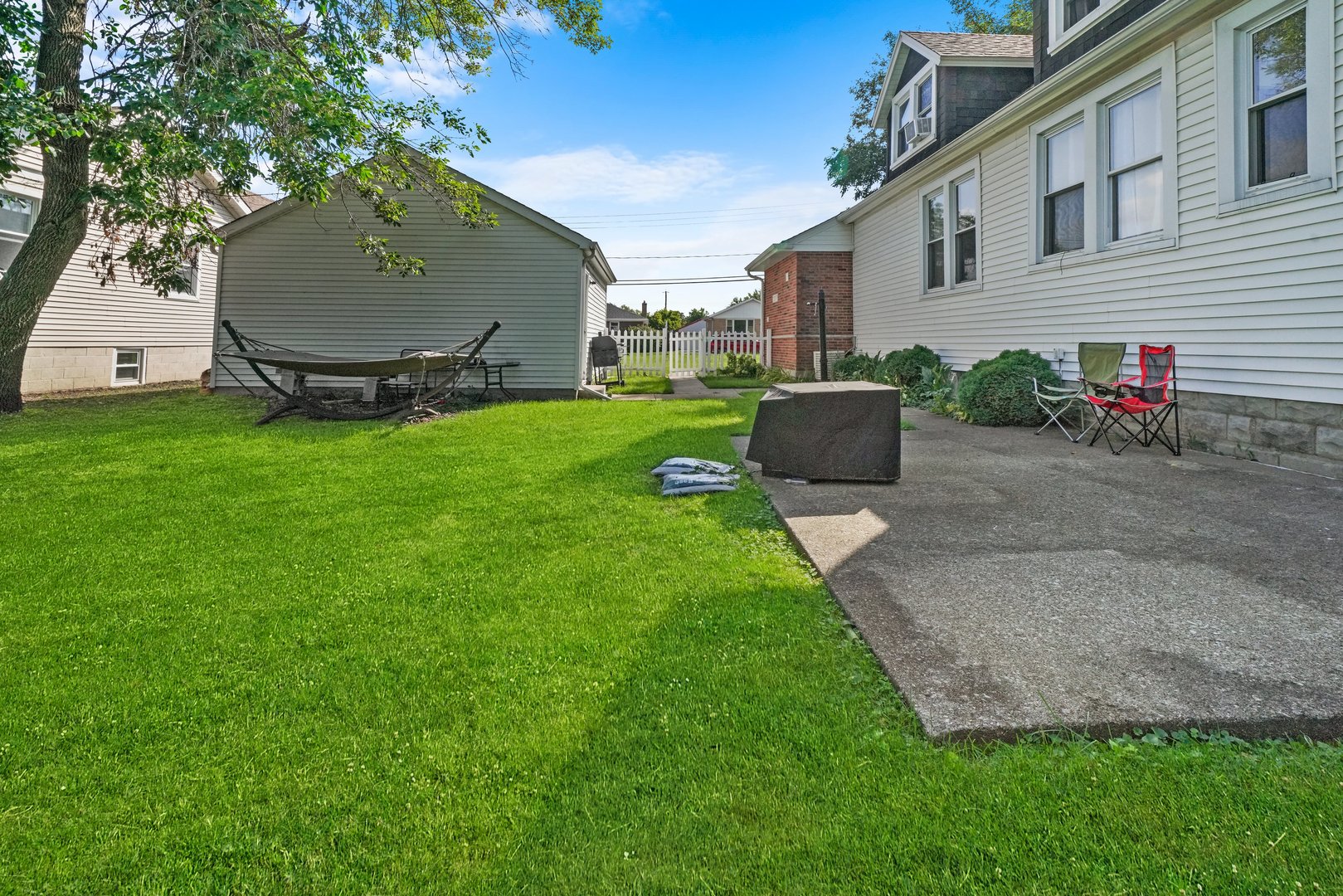 5648 Hawthorne Avenue Berkeley, IL 60163 - Photo 23 of 25 a view of a backyard with potted plants and a large tree