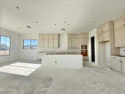 a large kitchen with kitchen island a sink stainless steel appliances and cabinets