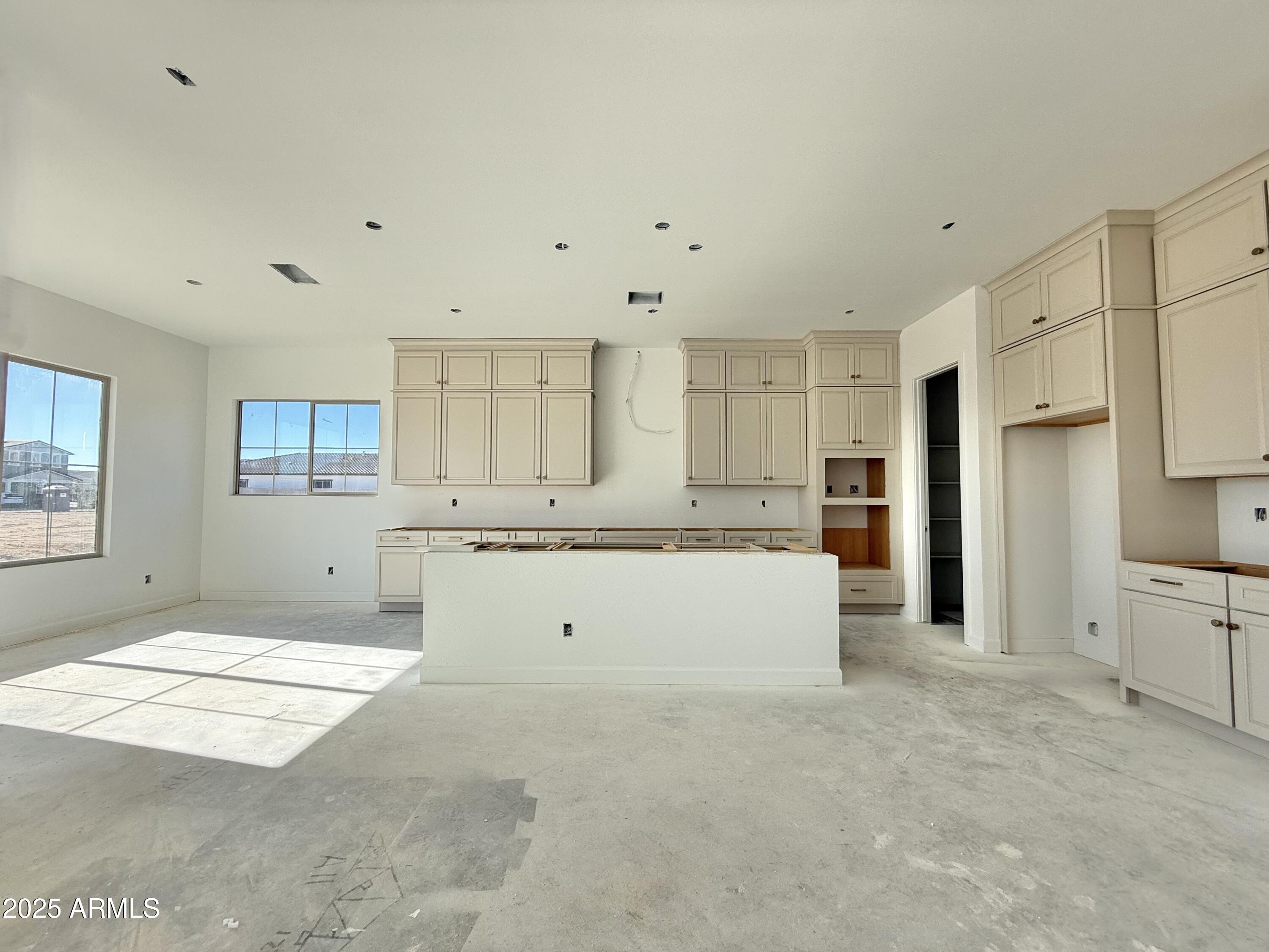 22757 East Saddle Way Queen Creek, AZ 85142 - Photo 12 of 34 a large kitchen with kitchen island a sink stainless steel appliances and cabinets