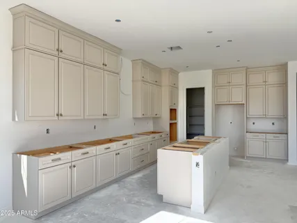 a room with white cabinets and appliances