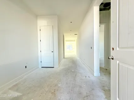 an empty room with windows and closet